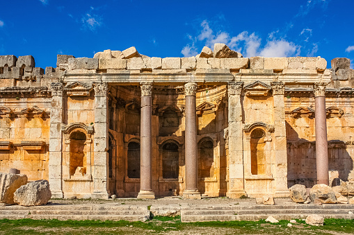 Photo of pillars and an exedra with niches of the Great Court of the temple complex and the Temple of Jupiter in Baalbek, Lebanon, a World Heritage Site.