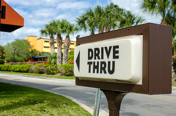 Drive Thru A drive thru sign advertising a fast food restaurant fast food restaurant photos stock pictures, royalty-free photos & images