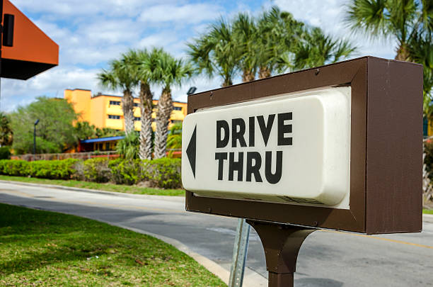 Drive Thru A drive thru sign advertising a fast food restaurant drive through photos stock pictures, royalty-free photos & images