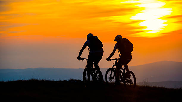 istock Cyclists on the Top of Mountain at Sunset 520325411