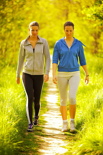 健康的なライフスタイル - nordic walking walking relaxation exercise women ストックフォトと画像