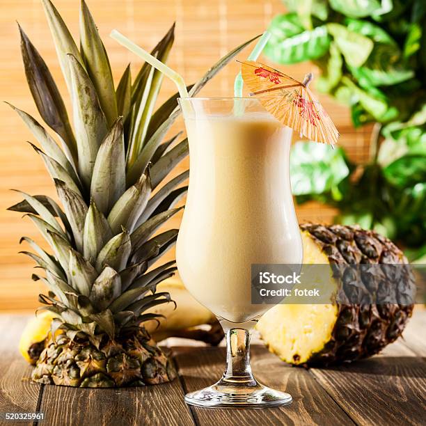Pina Colada On Wooden Background Garnished Pineapple Stock Photo - Download Image Now