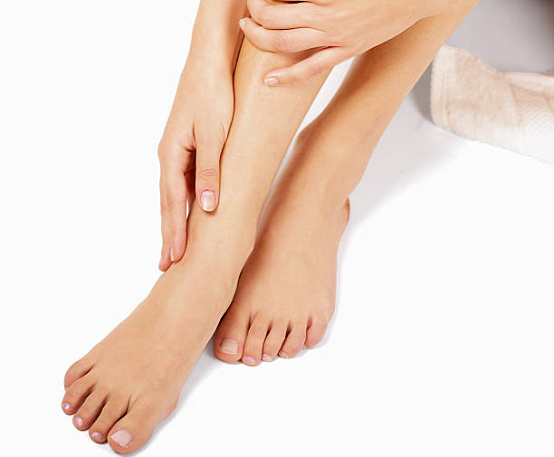 istock Female feet isolated on white background 520327063