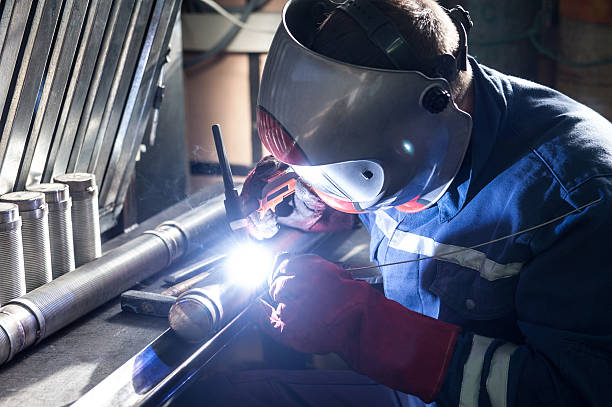 istock Closeup of man wearing mask welding in a workshop 520328450