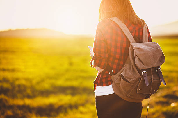 istock Young woman using her phone in nature 520328968