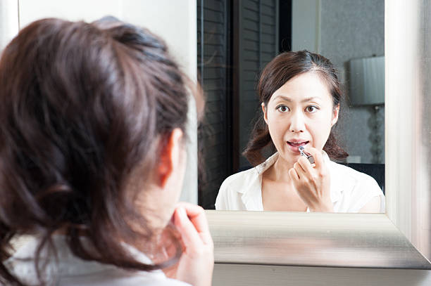 istock Women who have a makeup look in the mirror 520330578