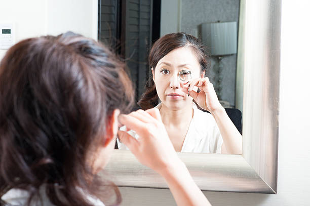 istock Women who have a makeup look in the mirror 520330622