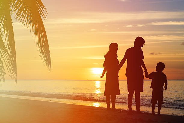 istock happy family with two kids on sunset beach 520332330