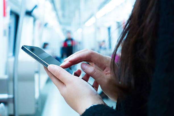 istock Woman using her phone in subway 520332654