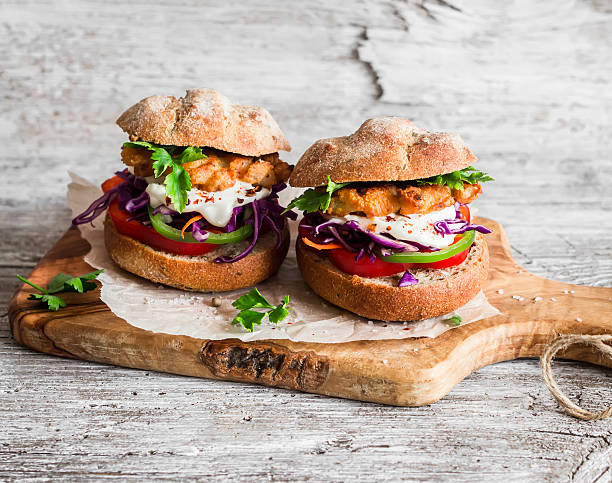 istock Homemade  fish burger on a light rustic wooden board 520335932