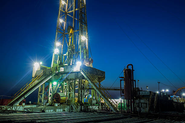 istock oilfield derrick at night 520336074