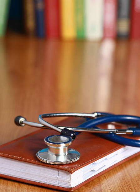 istock Stethoscope is lying with a book on the desk against 520358577