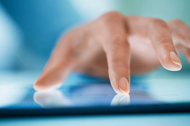 istock Woman using tablet pc, close-up on fingers 520359101