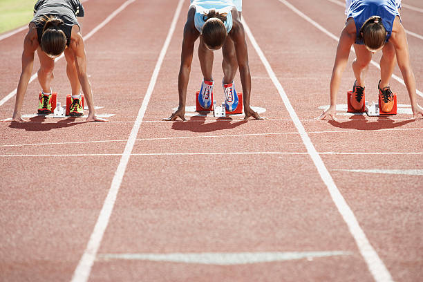 Runners in starting blocks Runners in starting blocks hurdle stock pictures, royalty-free photos & images