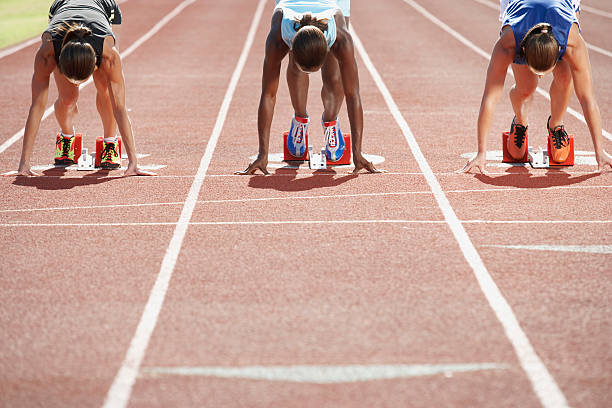 Runners in starting blocks Runners in starting blocks track starting block stock pictures, royalty-free photos & images