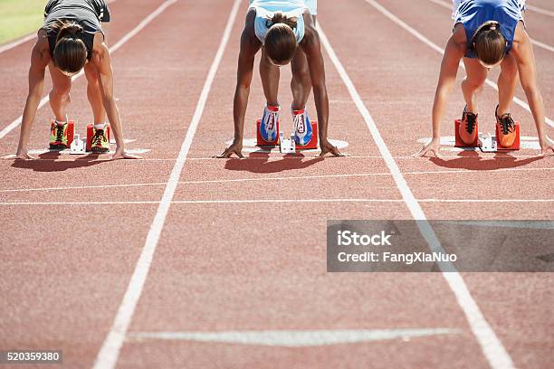 Runners In Starting Blocks Stock Photo - Download Image Now - Running, Track And Field, Starting Line