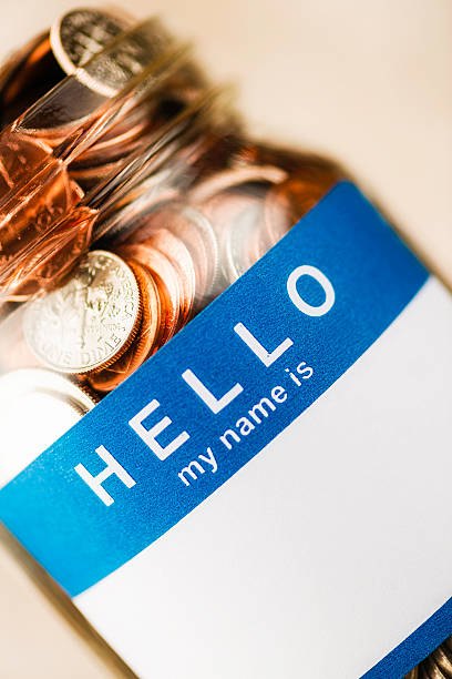 istock Donation jar with blank label filled with American currency 520359497