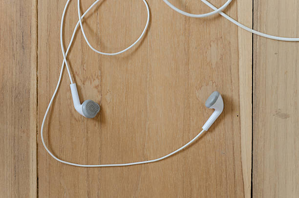 istock earpiece on wooden background 520359766