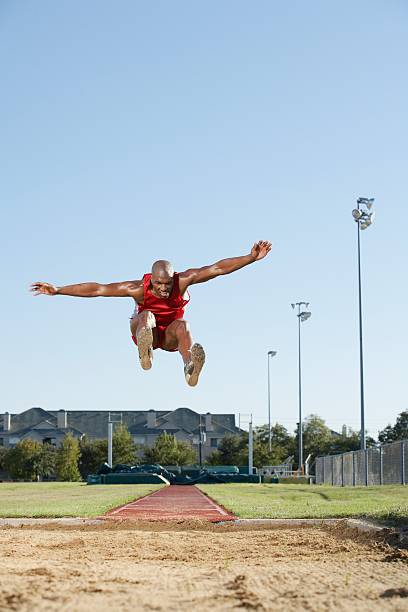 Long jumper in air Long jumper in air long jump stock pictures, royalty-free photos & images