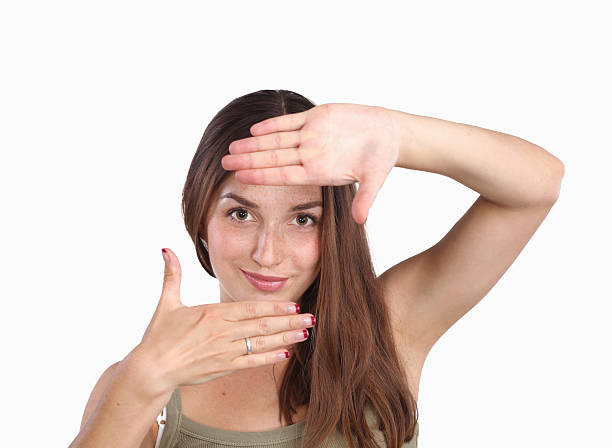 istock Young attractive woman framing her hands 520361445