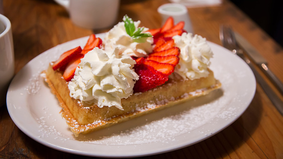 Belgian Waffles served with whipped cream and strawberries