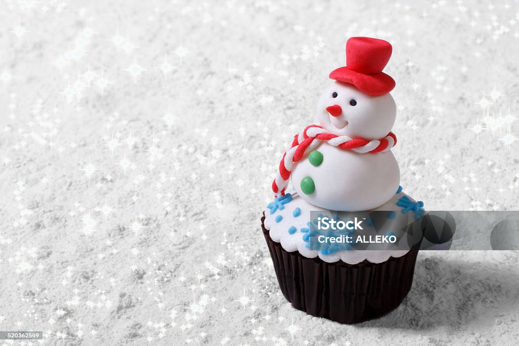 Cupcake Christmas snowman on white snow. horizontal Chocolate Cupcake Christmas snowman on white snow. horizontal Cupcake Stock Photo