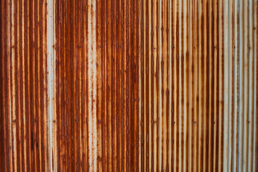 Photograph of heavily rusted corrugated iron for background or texture effect.