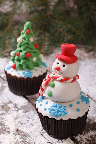 istock Cupcake Christmas snowman on the background of fir trees 520363473