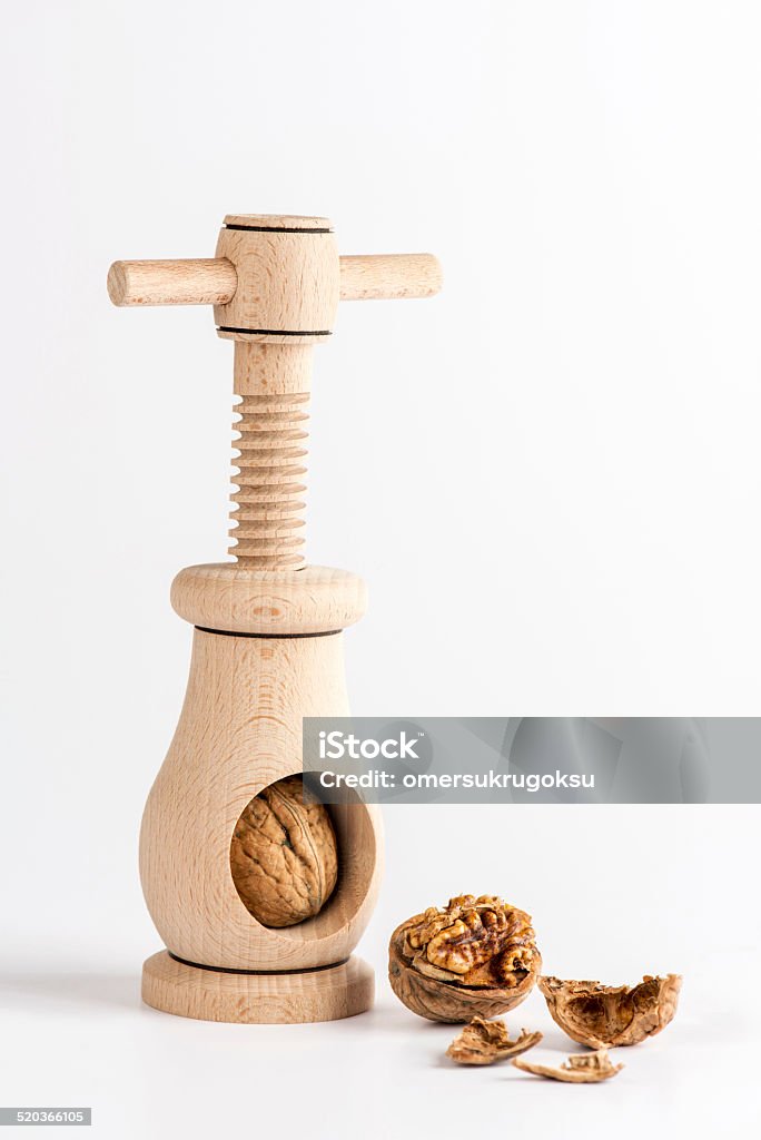 Nutcracker Nutcracker with walnut and shell on white background. Appliance Stock Photo