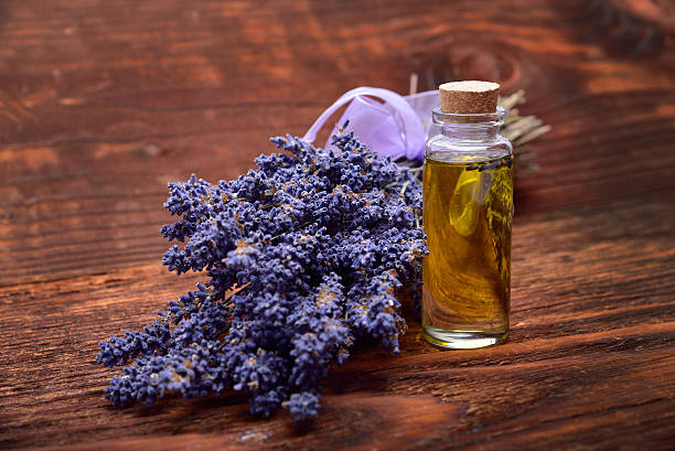 lavander oil with flower on wooden background stock photo
