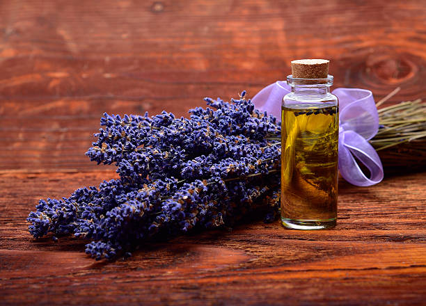 lavander oil with flower on wooden background stock photo