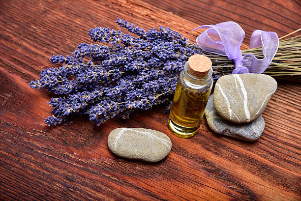 lavander oil with flower on wooden background stock photo