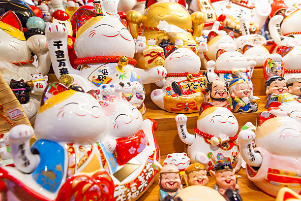 Group of Maneki Neko – lucky cats Group of Maneki Neko – lucky cat, common Japanese lucky charm, talisman which is often believed to bring good luck to the owner.  They are usually made of ceramic or plastic. maneki neko stock pictures, royalty-free photos & images