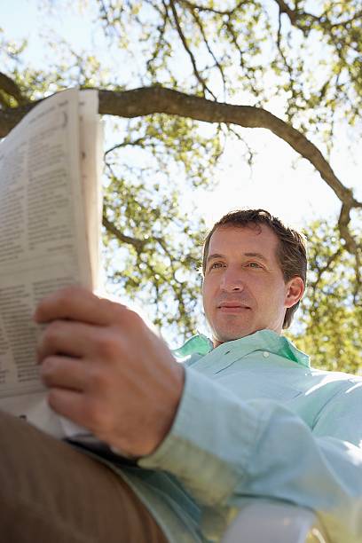 istock Man reading the newspaper outdoors 520368108