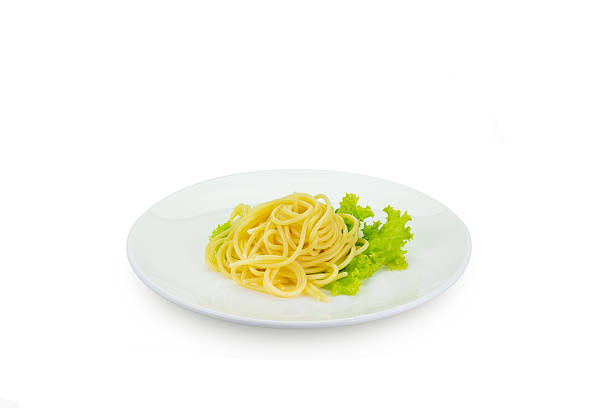 istock spaghetti with lettuce on white dish, isolated clipping path 520370202