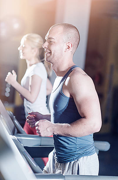 istock Two caucasian athletes warming up on treadmill in gym 520370870