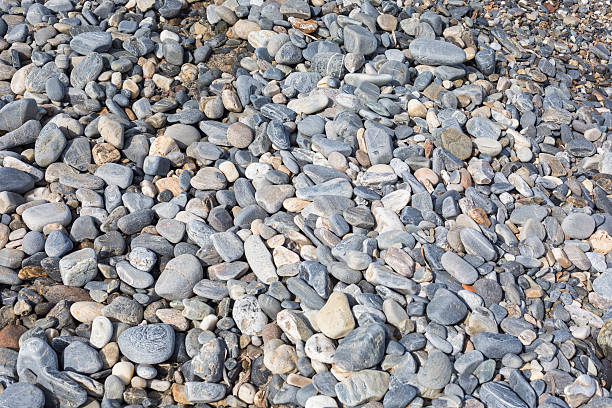 istock Sea stones or the wet smooth black stone 520371080