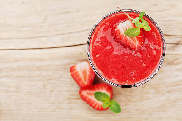 istock Strawberry smoothie in a glass decorated with mint leaves 520371966