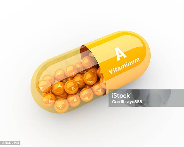 Vitamin A Capsule Lying On Desk Stock Photo - Download Image Now - Addiction, Backgrounds, Capsule - Medicine