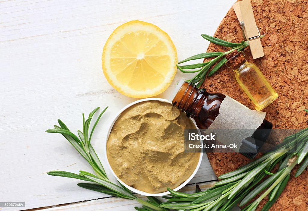 Cosmetic clay facial mask clay, rosemary oil and herbs, lemon. Body wrap domestic treatment. Top view. Clay Stock Photo