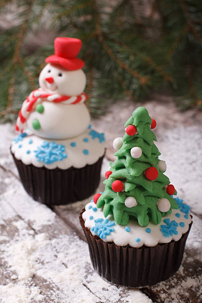 istock Cupcake Christmas tree on background with snowman 520387177