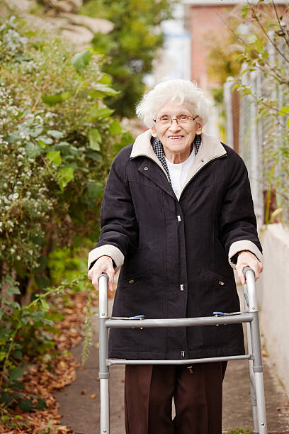 istock Senior Woman Walking Outdoors WIth Walker 520388393