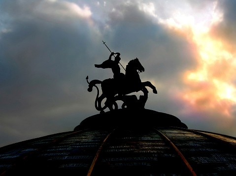 Monument of Saint George on spherical roof in the center of Moscow over dramatic cloudy sky