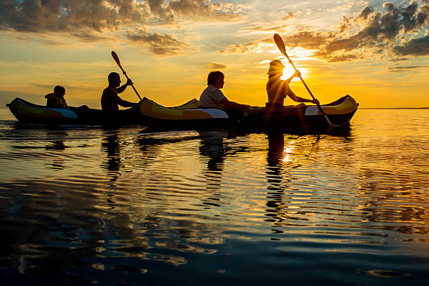 istock Family Sea Kayaking at Sunset 520388885