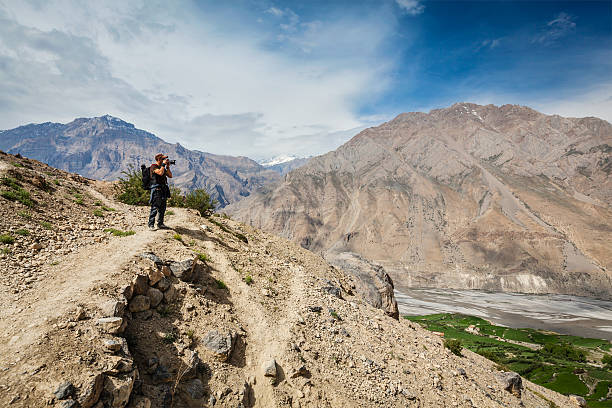 istock Photographer taking photos in Himalayas 520393613