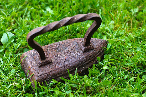 antique iron ,  Old iron on green grass ,