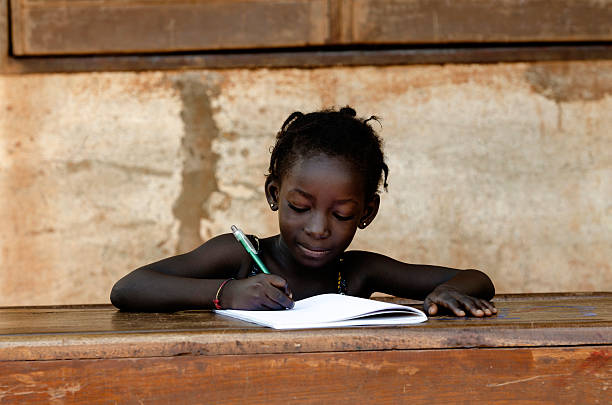 istock Helping Hand Symbol: Young African School Girl Learning Lesson 520408109