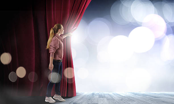 istock Girl opening curtain 520408551