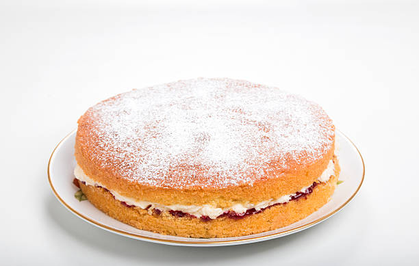 istock Making sponge cake, sliced and filled with jam and buttercream 520409091