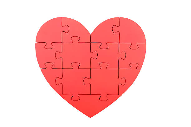 istock Red puzzle heart isolated on white 520409240